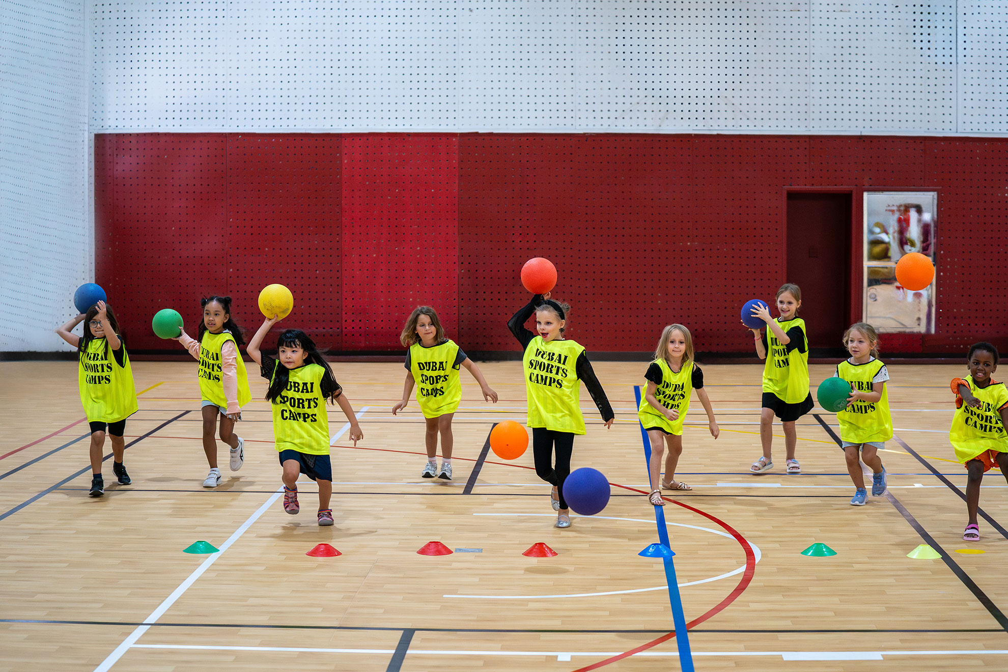 Kids enjoying an exciting game of dodgeball during camp activities
